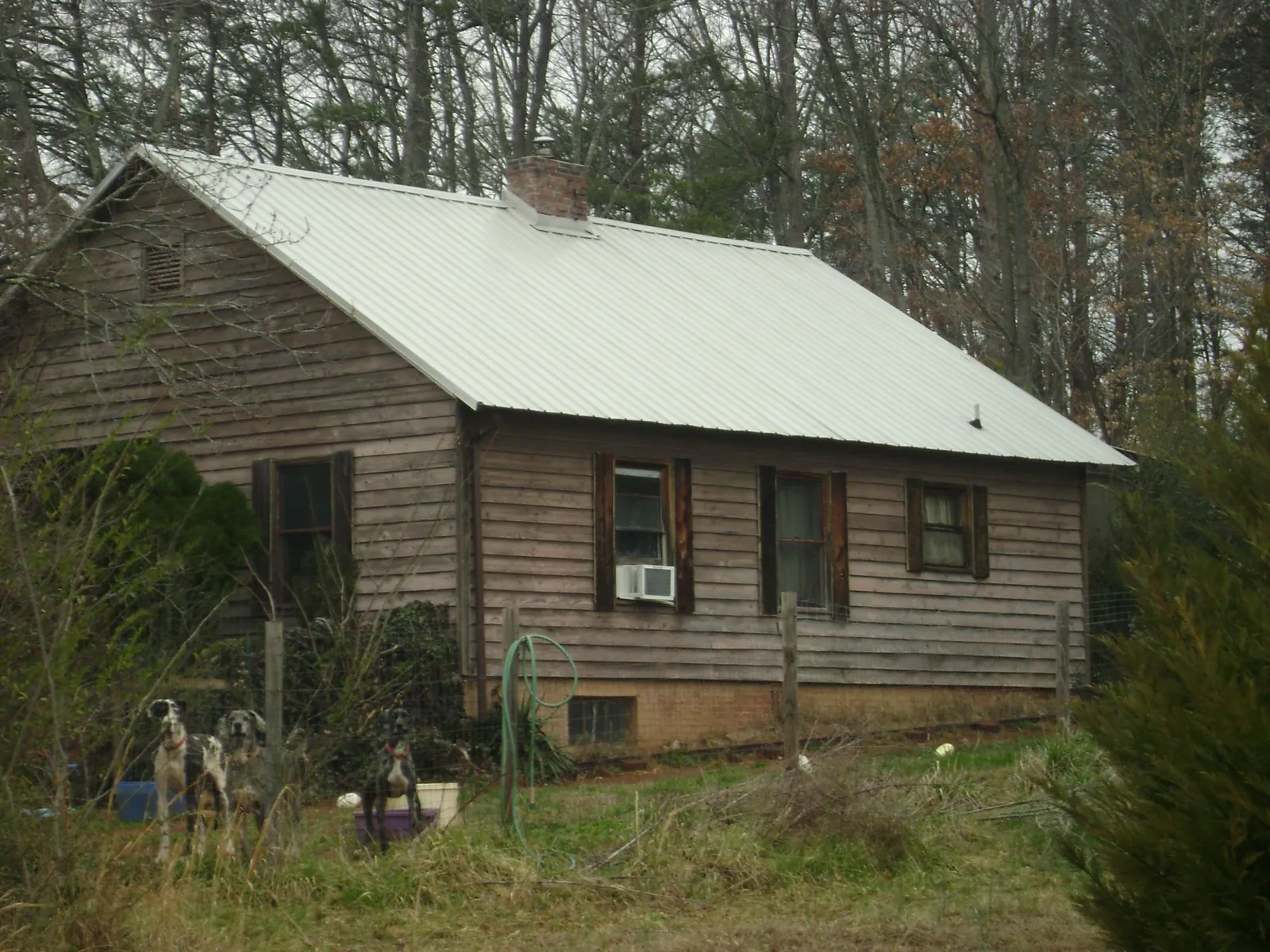 White metal roof on an old wood sided farmhouse, from a Metal Roof Installation job in Rhodhiss